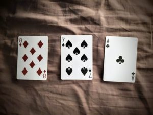 An image of the eight of diamonds, seven of spades, and ace of clubs.
