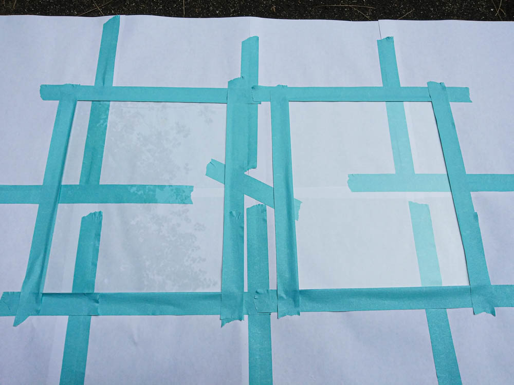 A photo of the glass panes with masking tape along their edges.